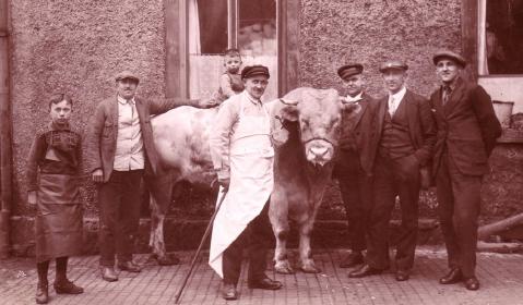 Im Hof der „Glocke“ vorn: Gustav Schettler, links: Sohn Max Schettler, auf dem Ochsen sitzt Manfred Rabe